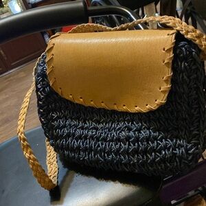 Navy blue crochet Crossbody with tan leather strap.